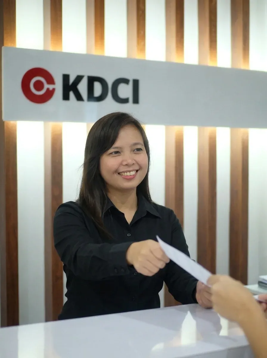 KDCI team member assisting a visitor at the office reception desk